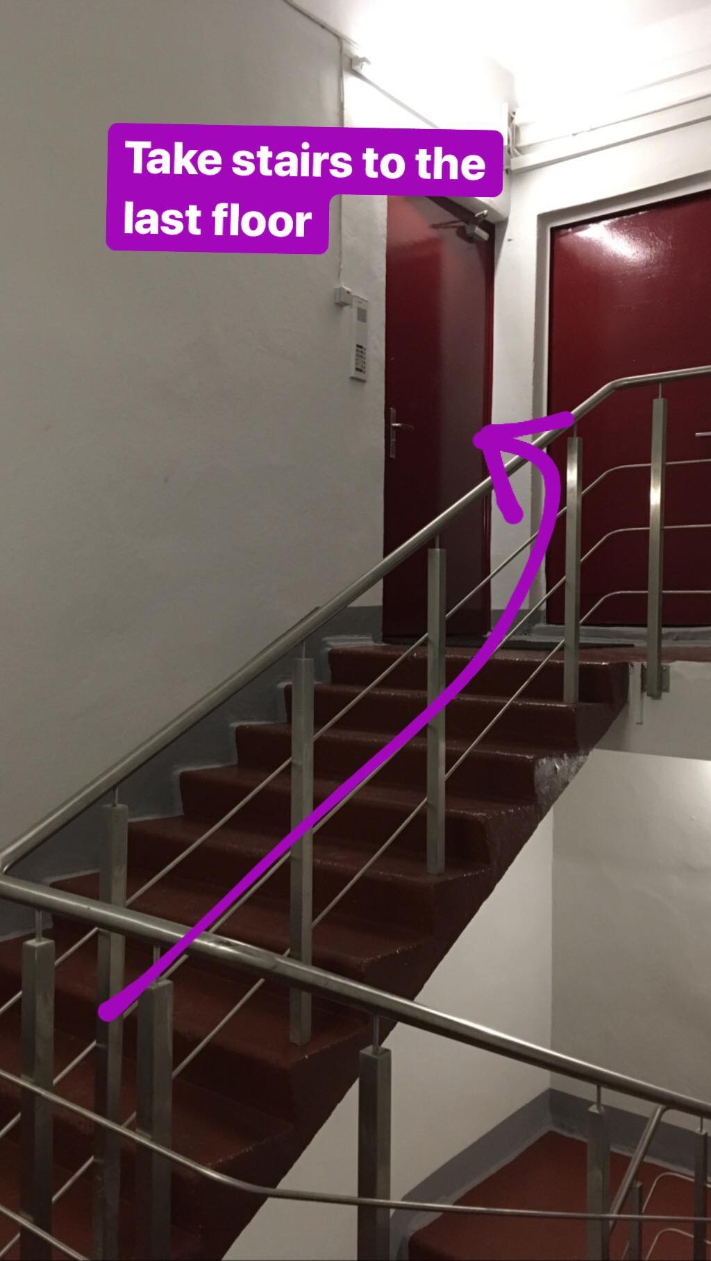 Take stairs to the last floor and enter through the left red door